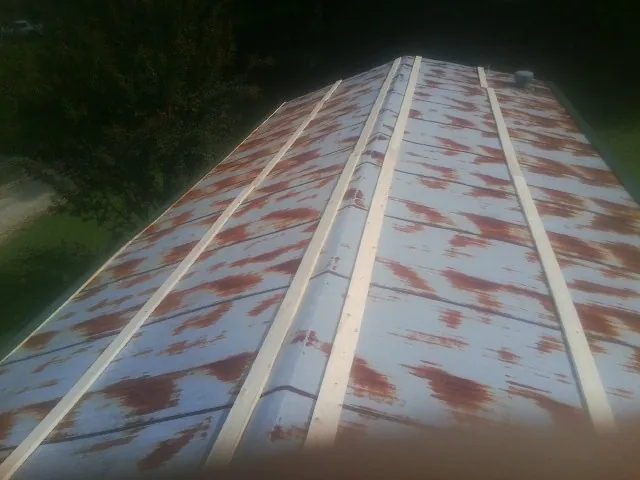 Rusted metal roof panels with new wood purlins before replacement — Storm Damage Roof Repair in Lake Huntington by Roofing Brothers
