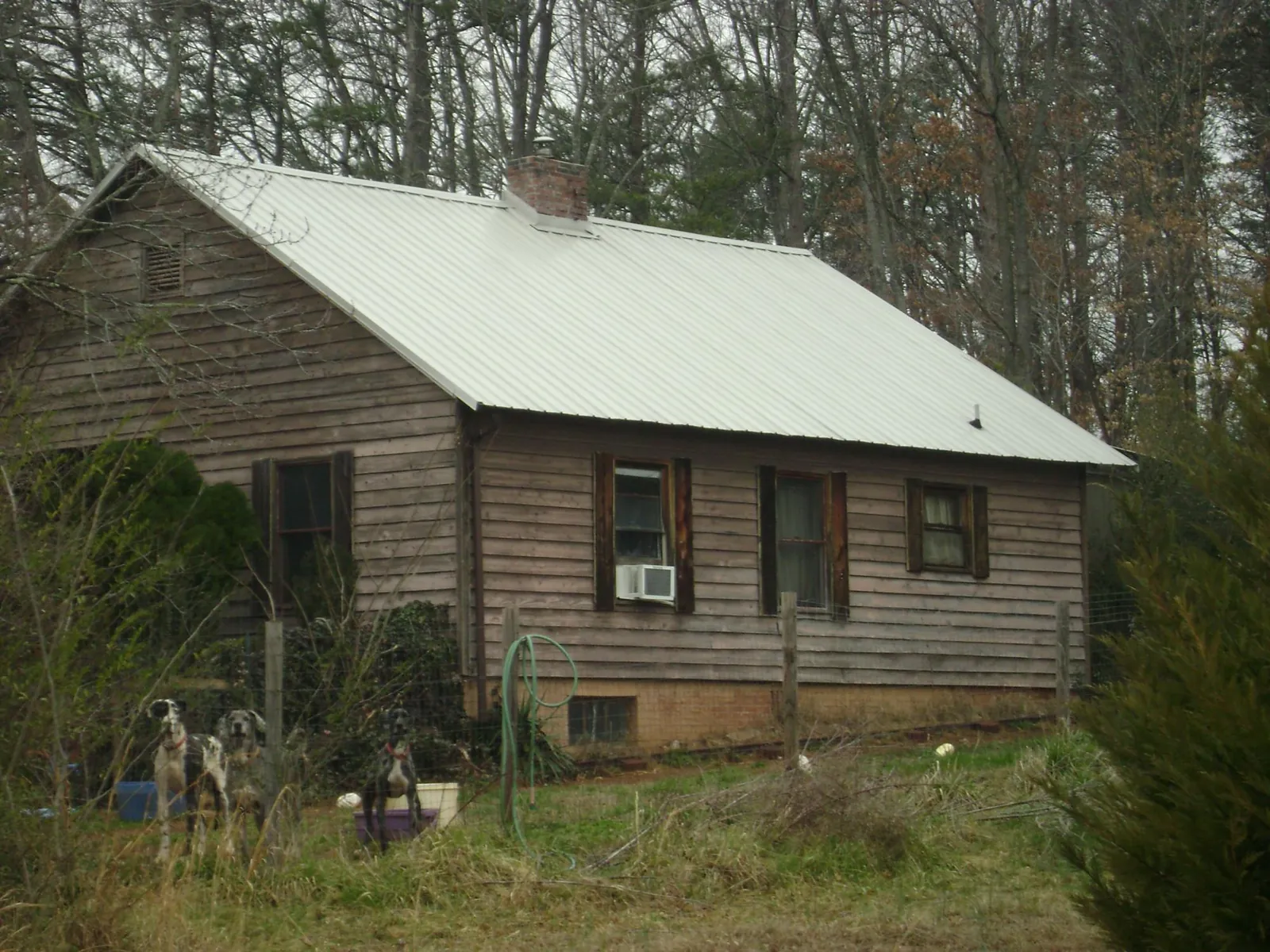 White metal roof on an old wood sided farmhouse, from a Metal Roof Installation job in Lake Huntington